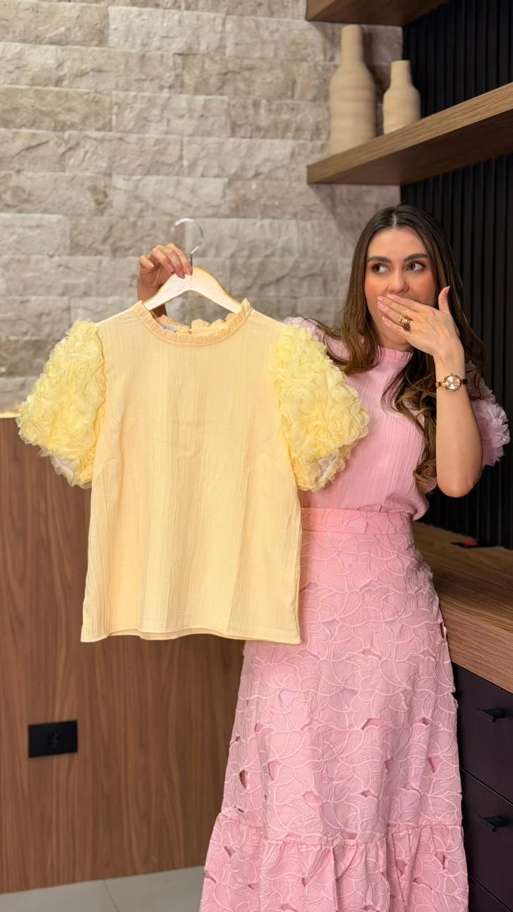 d4a25c284845ead8962f9fe2617679b4-blusinha-manga-flor-amarela.webp Blusa Confeccionada Em Tecido Plano, Com Modelagem Delicada E Mangas Volumosas Com Aplicações De Flores 3d, Que Trazem Charme E Sofisticação À Peça.